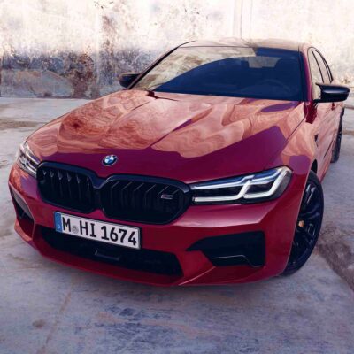 PaddleShifterz OEM BMW F90 M5 Competition LCI Front Grille Set - 51138082107, 51138082108 showing a red BMW F90 M5 LCI from the front
