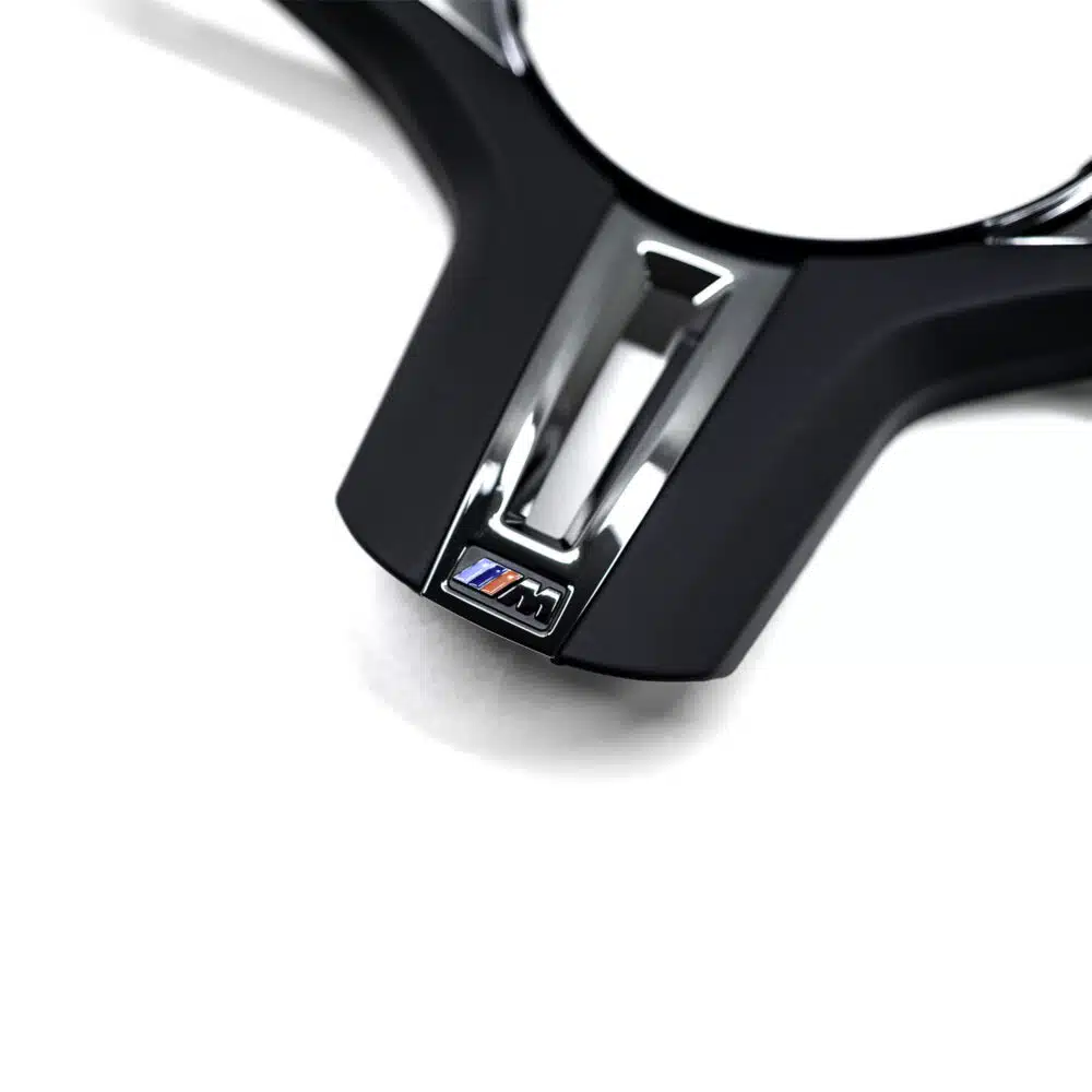 Close up shot of the OEM BMW F90 M5 CS gloss black steering wheel trim 32309503440