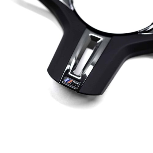 Close up shot of the OEM BMW F90 M5 CS gloss black steering wheel trim 32309503440
