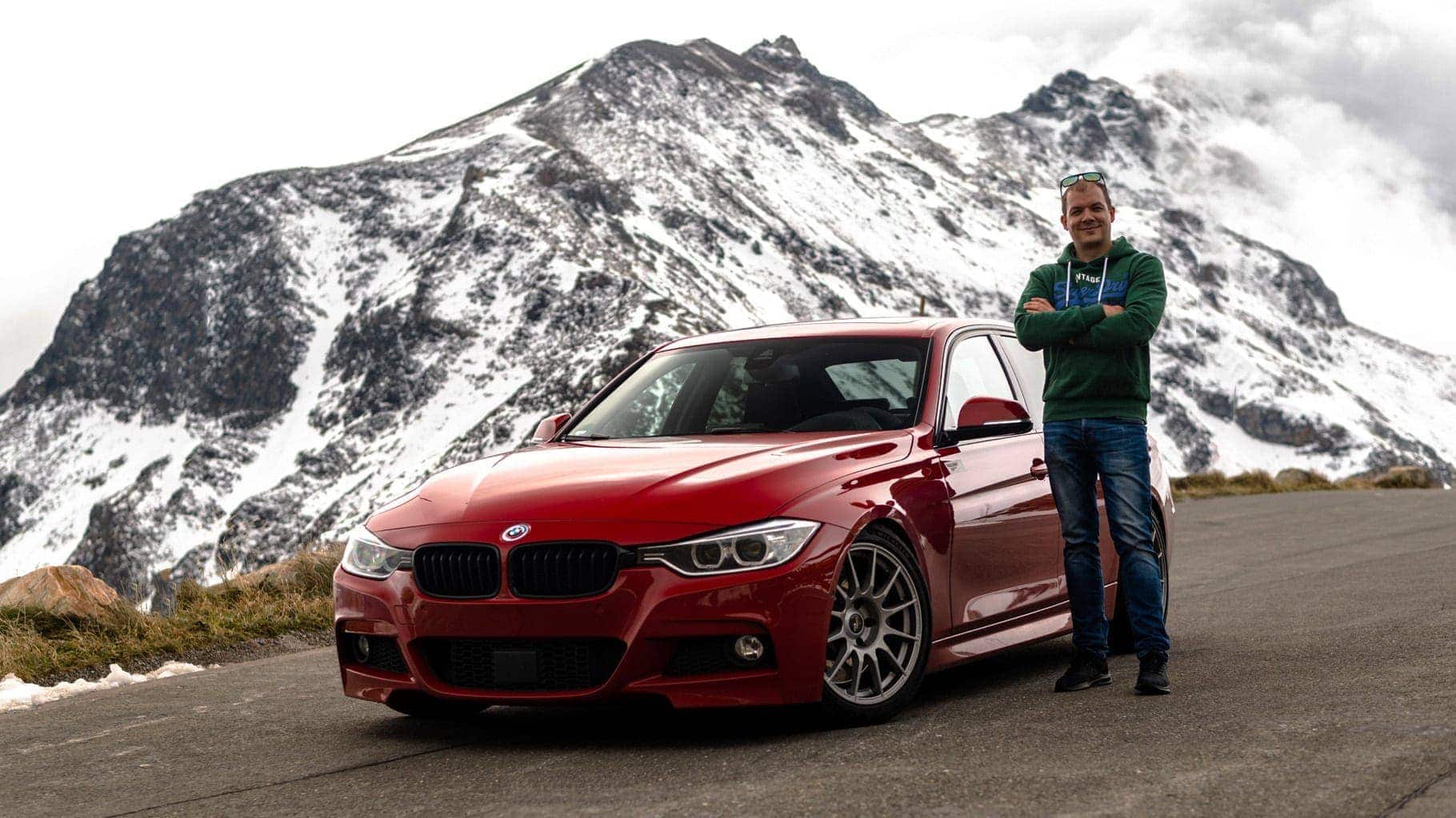 Man in green hoodie next to a Melbourne Red BMW F30 330d