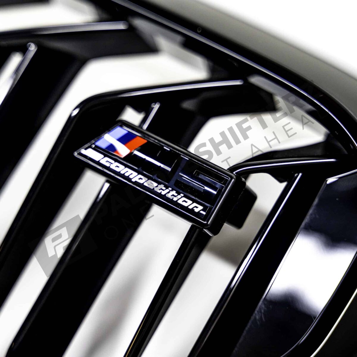 OEM BMW F90 M5 Competition gloss black Grille - 51138082107 close up shot of the M5 Competition logo