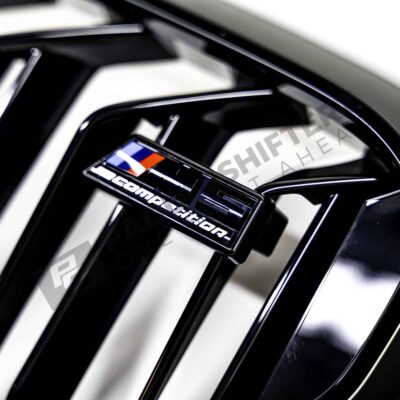 OEM BMW F90 M5 Competition gloss black Grille - 51138082107 close up shot of the M5 Competition logo