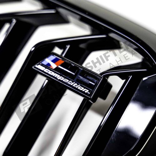 OEM BMW F90 M5 Competition gloss black Grille - 51138082107 close up shot of the M5 Competition logo