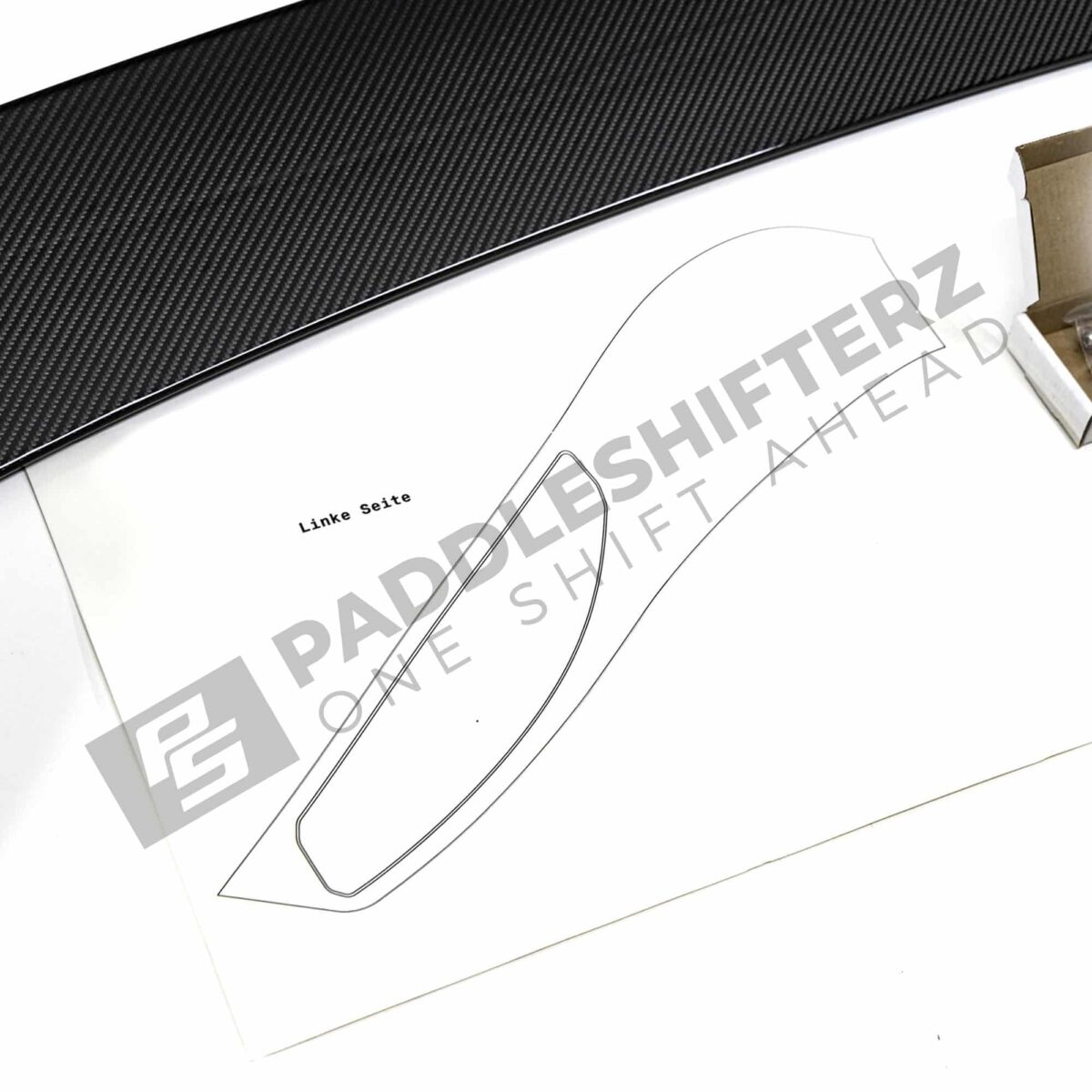 Close up view of the template of OEM BMW M Perf G87 gloss carbon fiber wing – 516625B33F50
