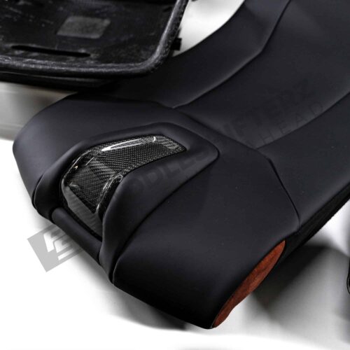Close up shot of the bottom part of the OEM BMW G82 M4 CSL Complete Left Carbon fiber bucket seat