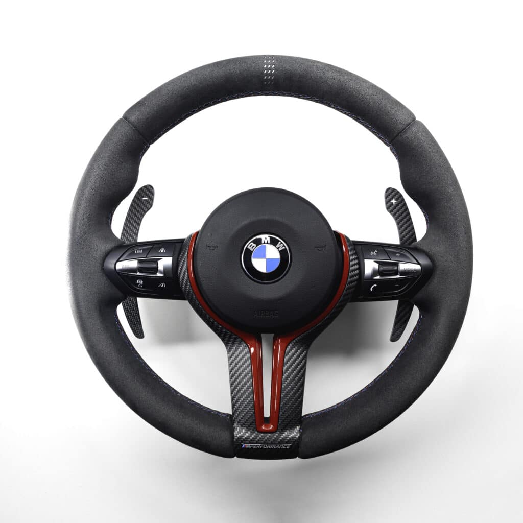 structured carbon fiber paddle shifters on a BMW F87 M2 alcantara steering wheel