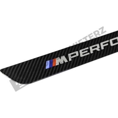 Close up of OEM BMW M Performance Carbon door sill trim - 51475A6CBC3