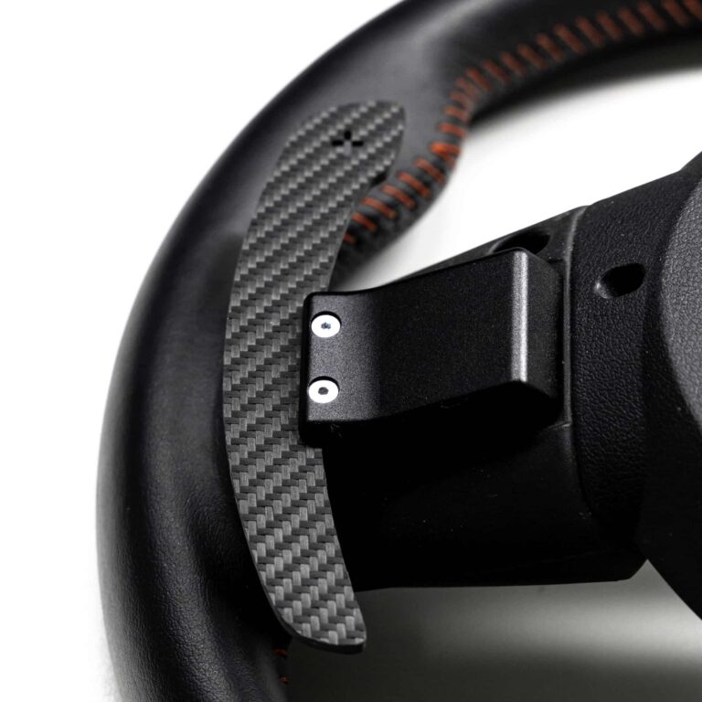 Structured carbon fiber paddle shifters for MINI F Series on a wheel from the rear