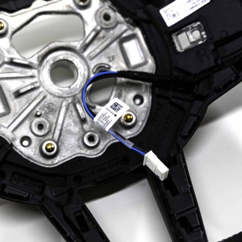 Close up shot of the OEM BMW M4 Flat bottom alcantara steering wheel, 32307908500 showing the white heating cable