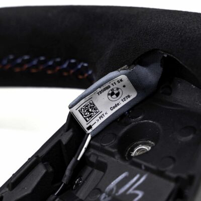 Close up shot of the BMW M4 Flat bottom alcantara steering wheel, 32307908501 showing the driving assistant cable