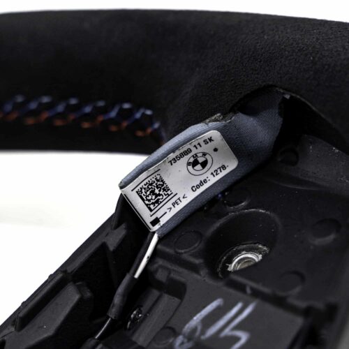 Close up shot of the BMW M4 Flat bottom alcantara steering wheel, 32307908501 showing the driving assistant cable