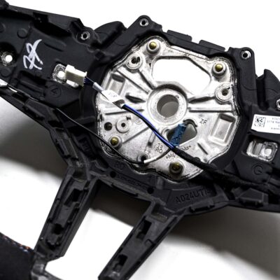 Close up shot of the OEM BMW M Flat bottom alcantara steering wheel 32307908502 showing the cables