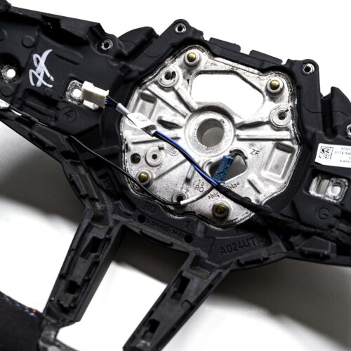Close up shot of the OEM BMW M Flat bottom alcantara steering wheel 32307908502 showing the cables