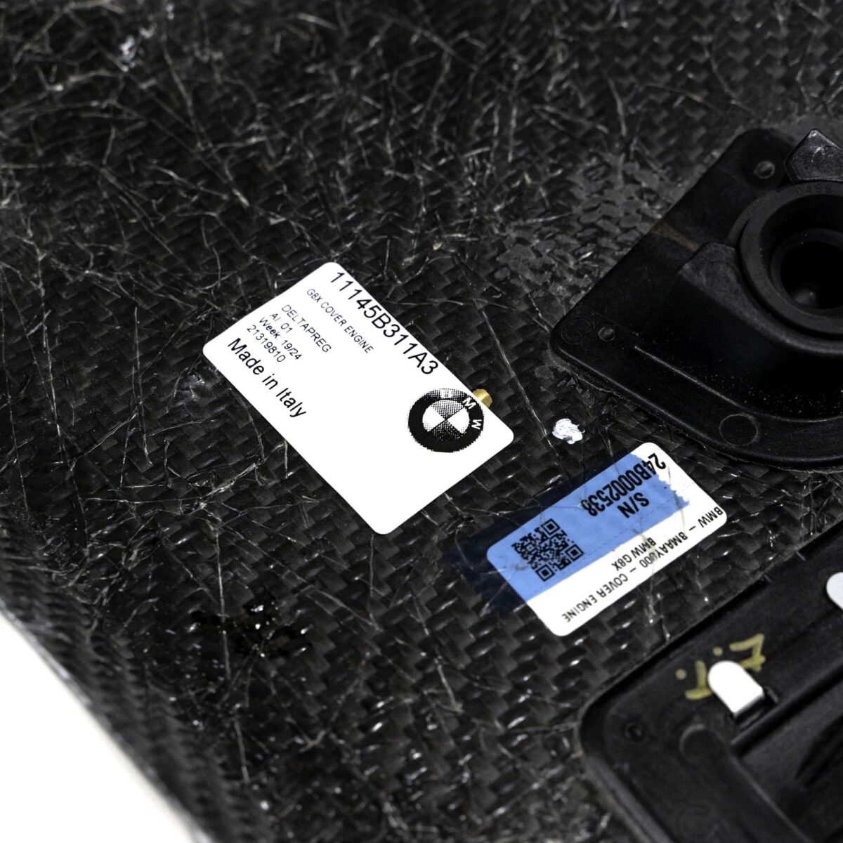 Close up shot of the OEM BMW Carbon fiber engine cover for S58 engines 11145B311A3 showing labels on the inside
