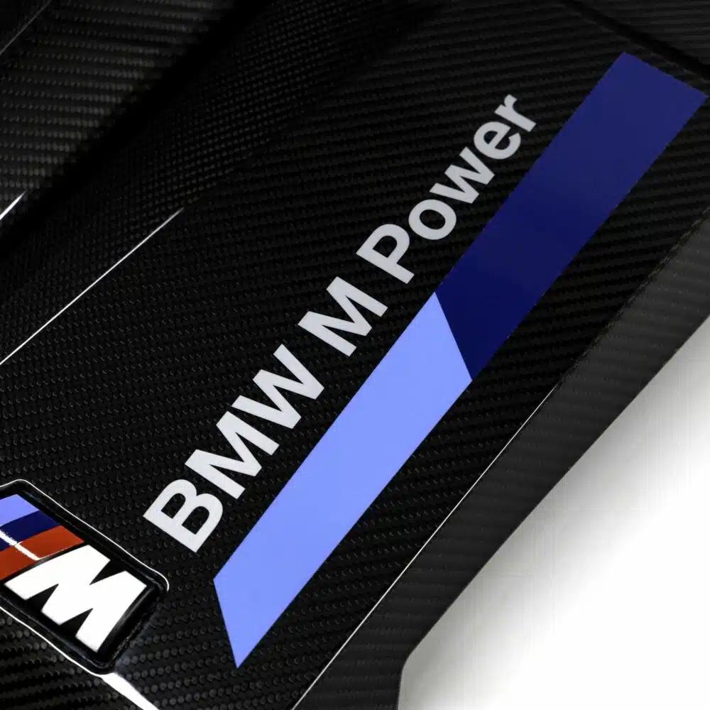 Close up shot of the OEM BMW Carbon fiber engine cover for S58 engines 11145B311A3 showing the BMW M Power logo