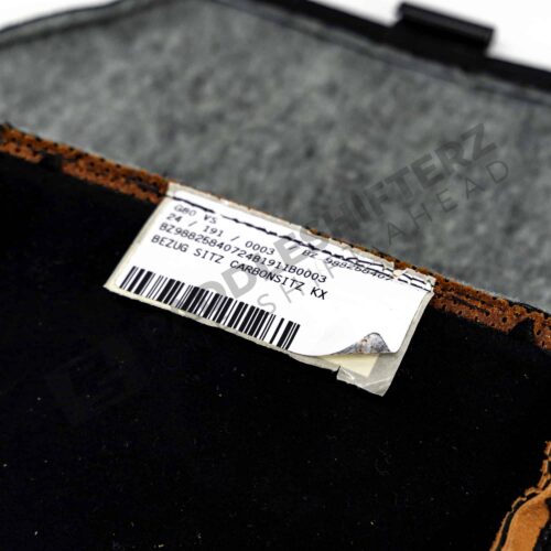 Close up view of the OEM BMW Carbon Seat Bottom Cover Kyalami Orange 52109882584