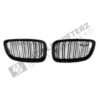 A top down shot of the PaddleShifterz OEM BMW Gloss Black front grilles BMW F87 M2 51712355447 51712355448 laid down on a white background