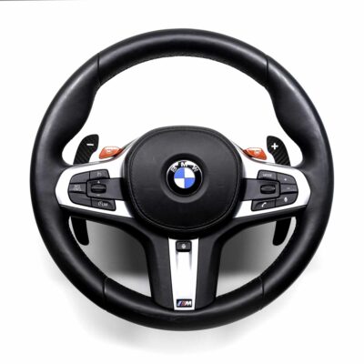 Gloss carbon fiber paddle shifters for F/G Series and Supra on a BMW M steering wheel