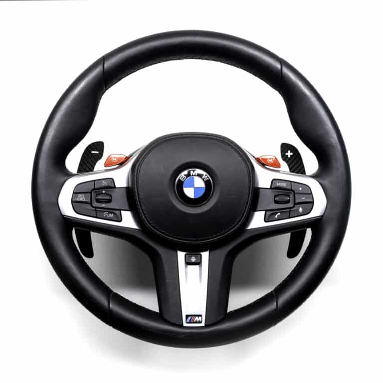 Gloss carbon fiber paddle shifters for F/G Series and Supra on a BMW M steering wheel