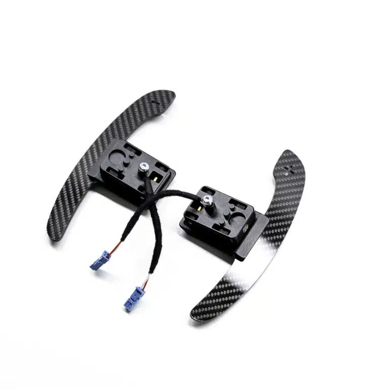 Gloss carbon fiber paddle shifters with magnetic component on a white background