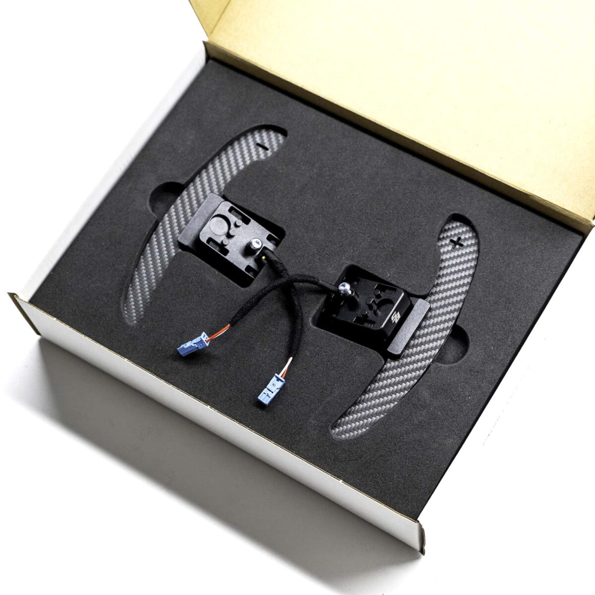 Magnetic paddle shifters in structured carbon fiber in a box with foam insert