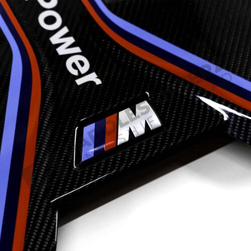 Close up shot of the M logo on the OEM BMW M Performance carbon engine cover - 11148058667