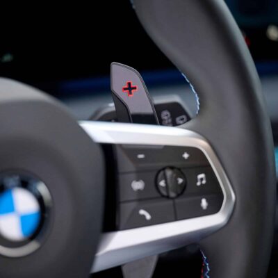 Close up shot of the OEM BMW M Extended gloss black paddle shifters - 61315A3B6A9
