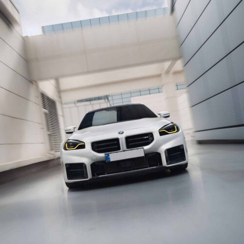 Oncoming shot of INDIV Carbon fiber front grilles for BMW G87 M2