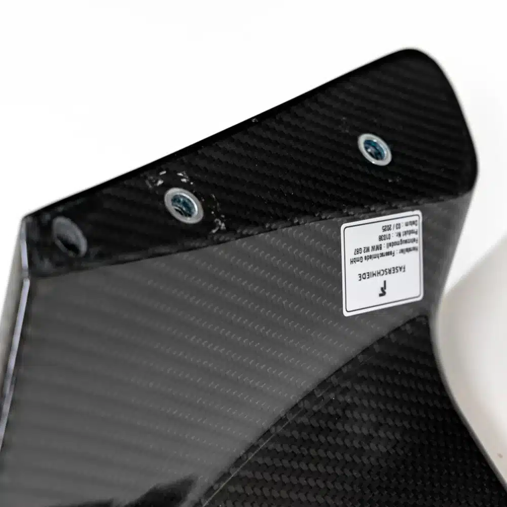 Close up photo of the feet of Competition Carbon fiber Rear Wing for BMW G87 M2