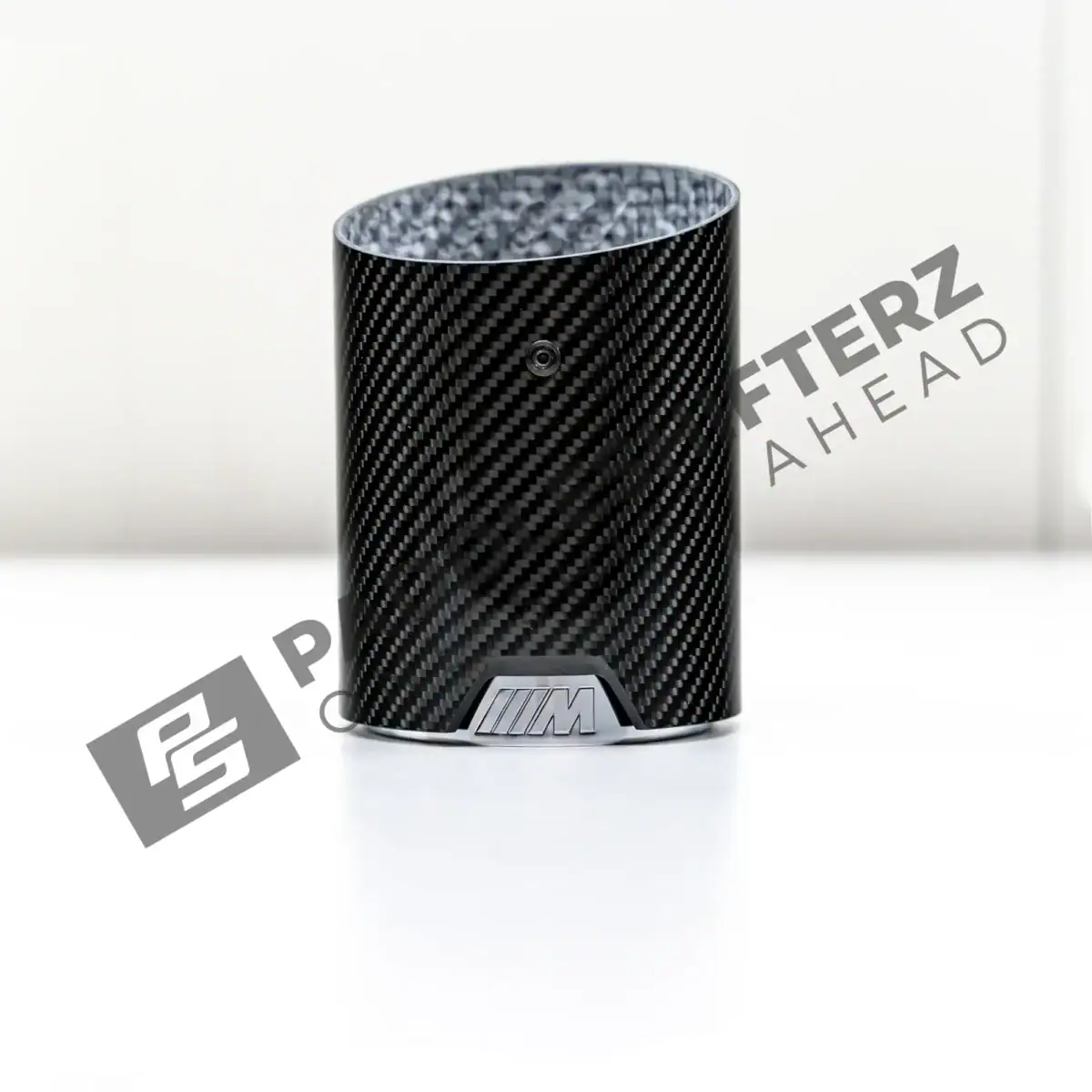 PaddleShifterz OEM BMW M Performance Carbon fiber exhaust tips F70 F74 18305B32892 flat on a table