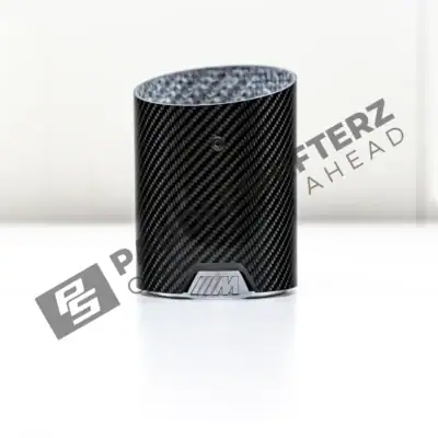 PaddleShifterz OEM BMW M Performance Carbon fiber exhaust tips F70 F74 18305B32892 flat on a table