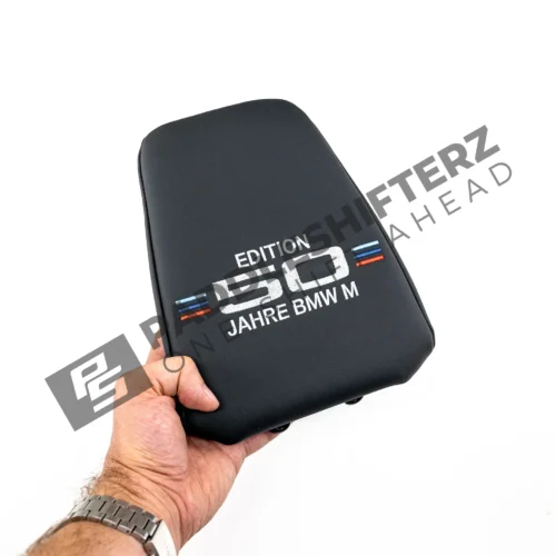 OEM BMW 50 Year M Edition Headrest - 52107858470 in a mans hand